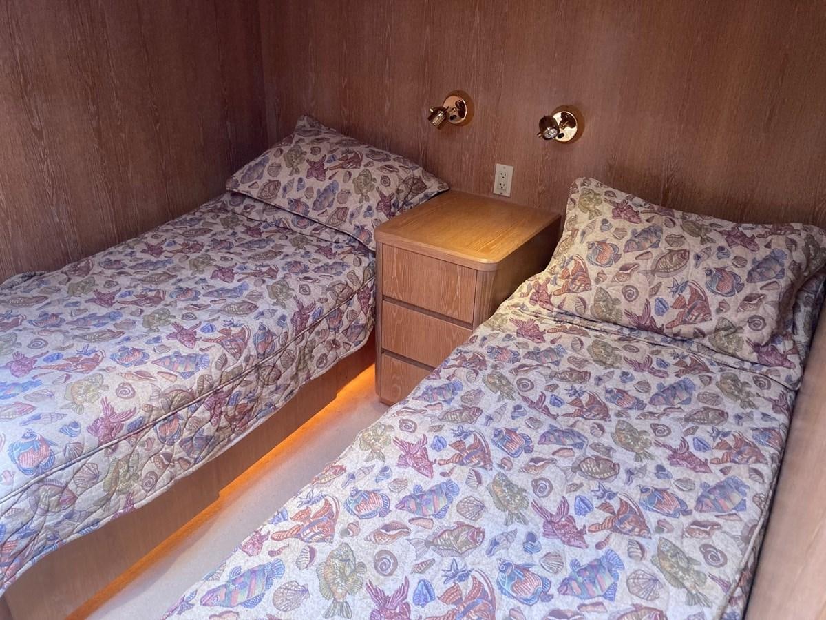 a bed with a blue comforter aboard LADY JANE Yacht for Sale