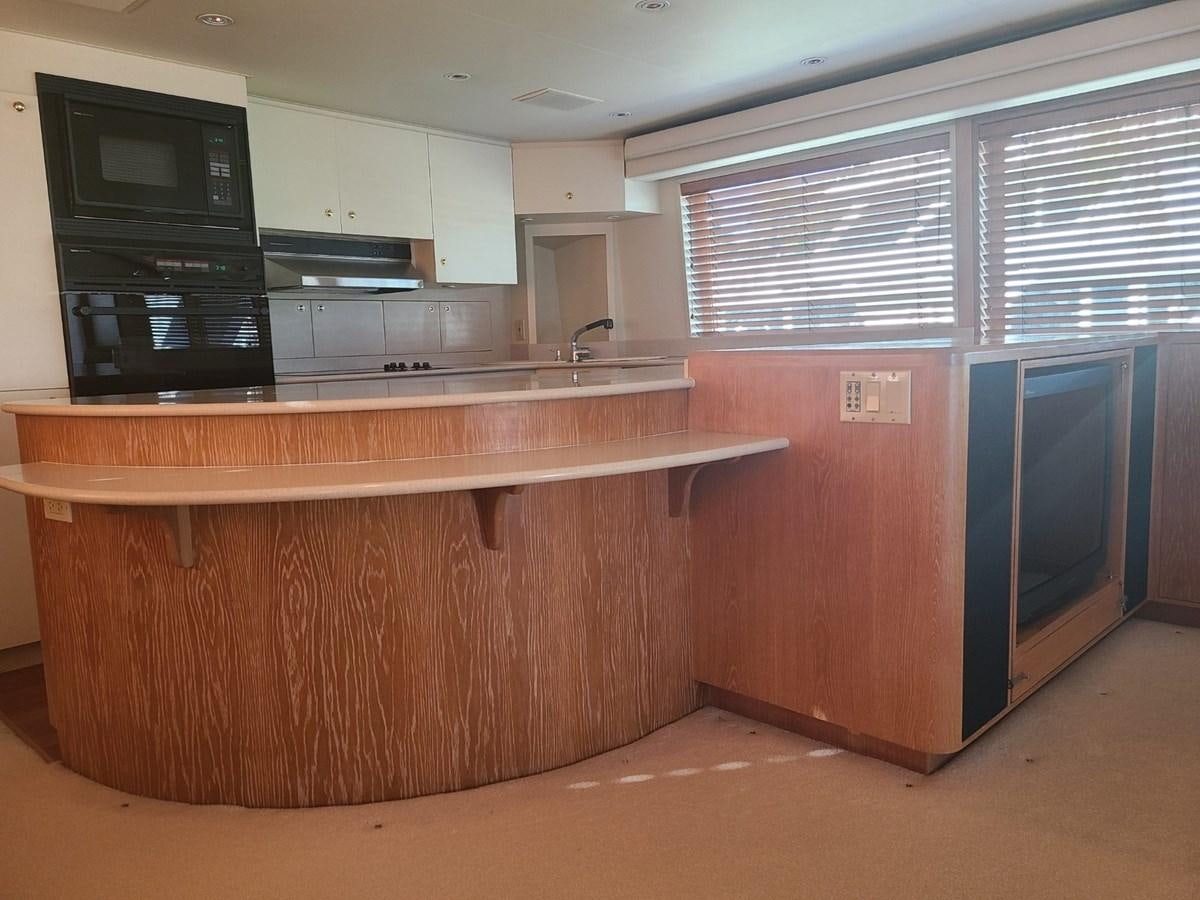 a kitchen with a microwave oven and cabinets aboard LADY JANE Yacht for Sale