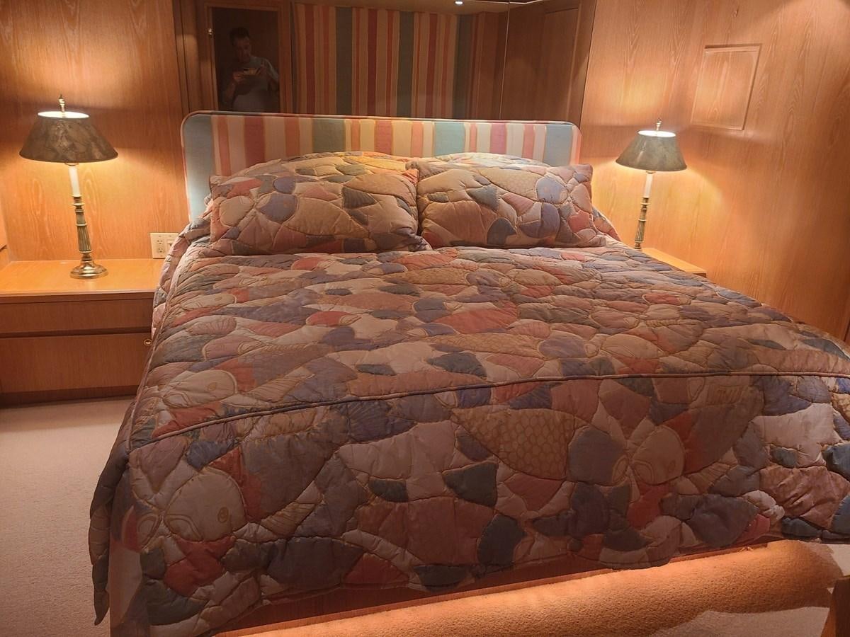 a bed with a blue comforter aboard LADY JANE Yacht for Sale