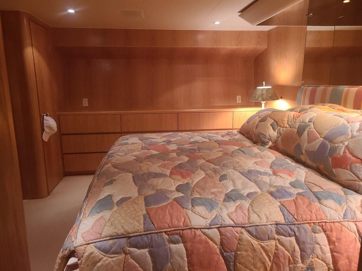 a bed with a blue comforter aboard LADY JANE Yacht for Sale