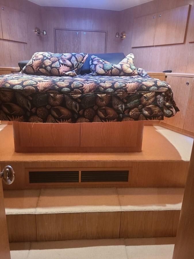 a bed with a wooden frame aboard LADY JANE Yacht for Sale