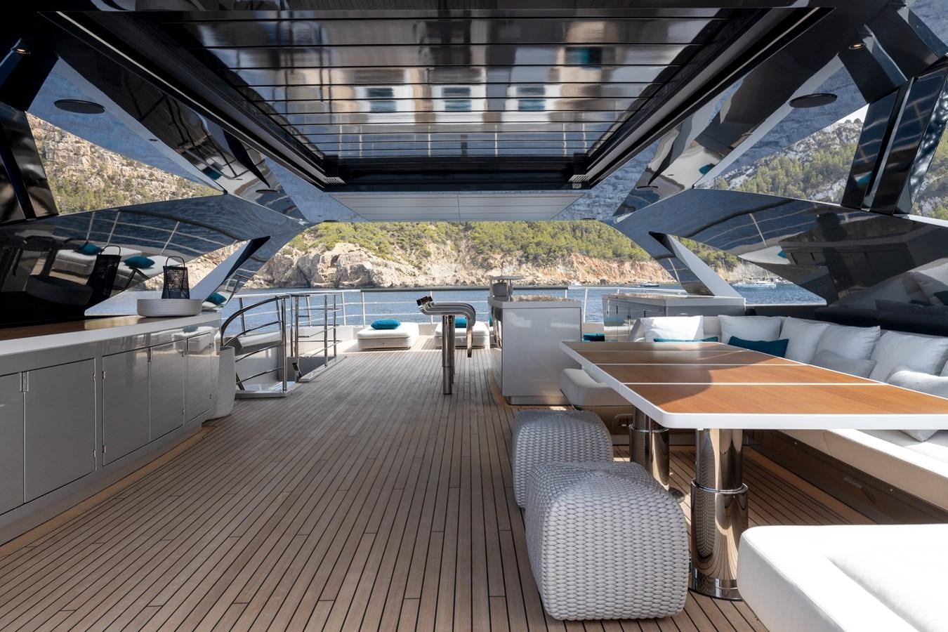 a room with a deck and chairs aboard NO STRESS Yacht for Sale