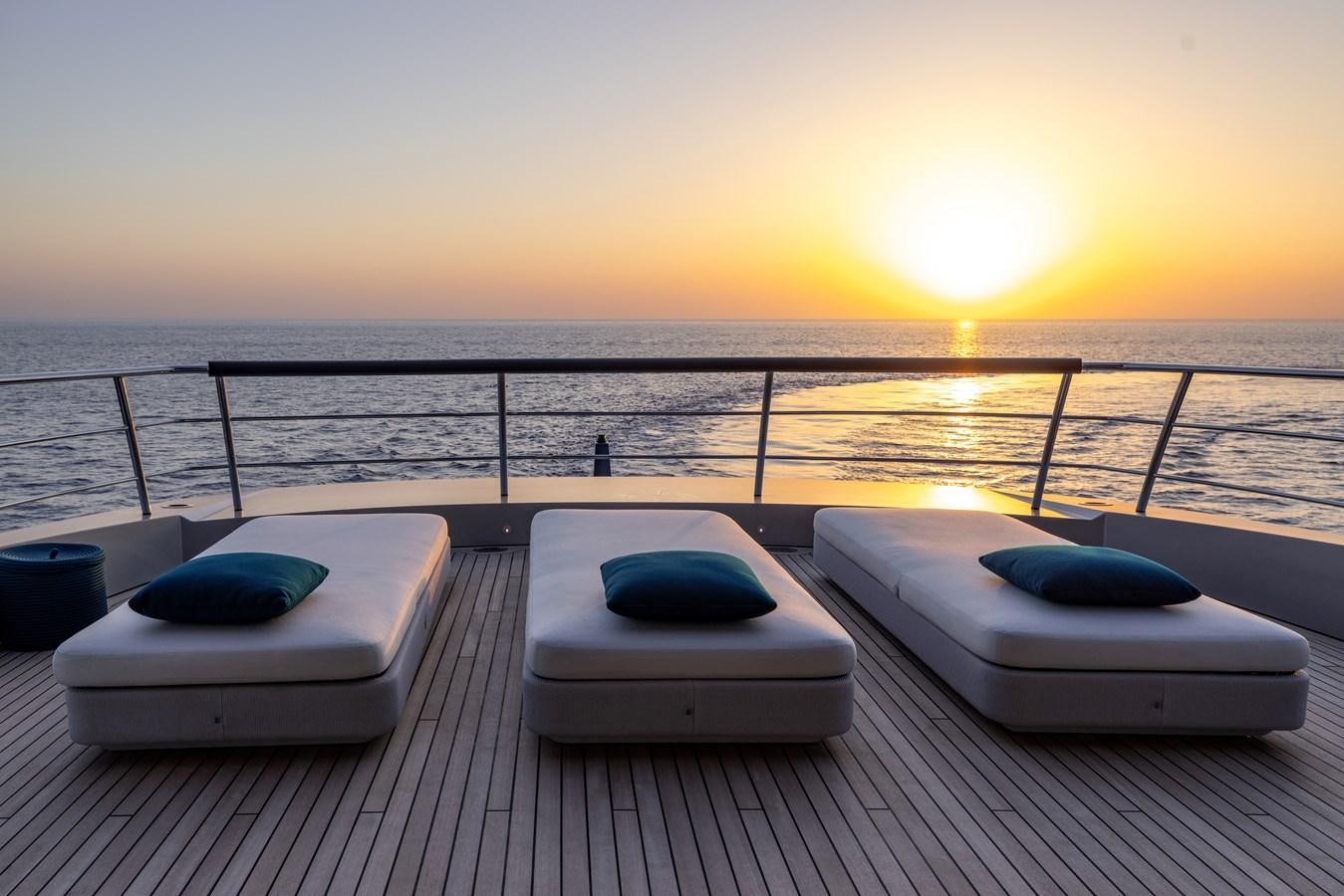 a deck with a view of the sunset and the ocean aboard NO STRESS Yacht for Sale