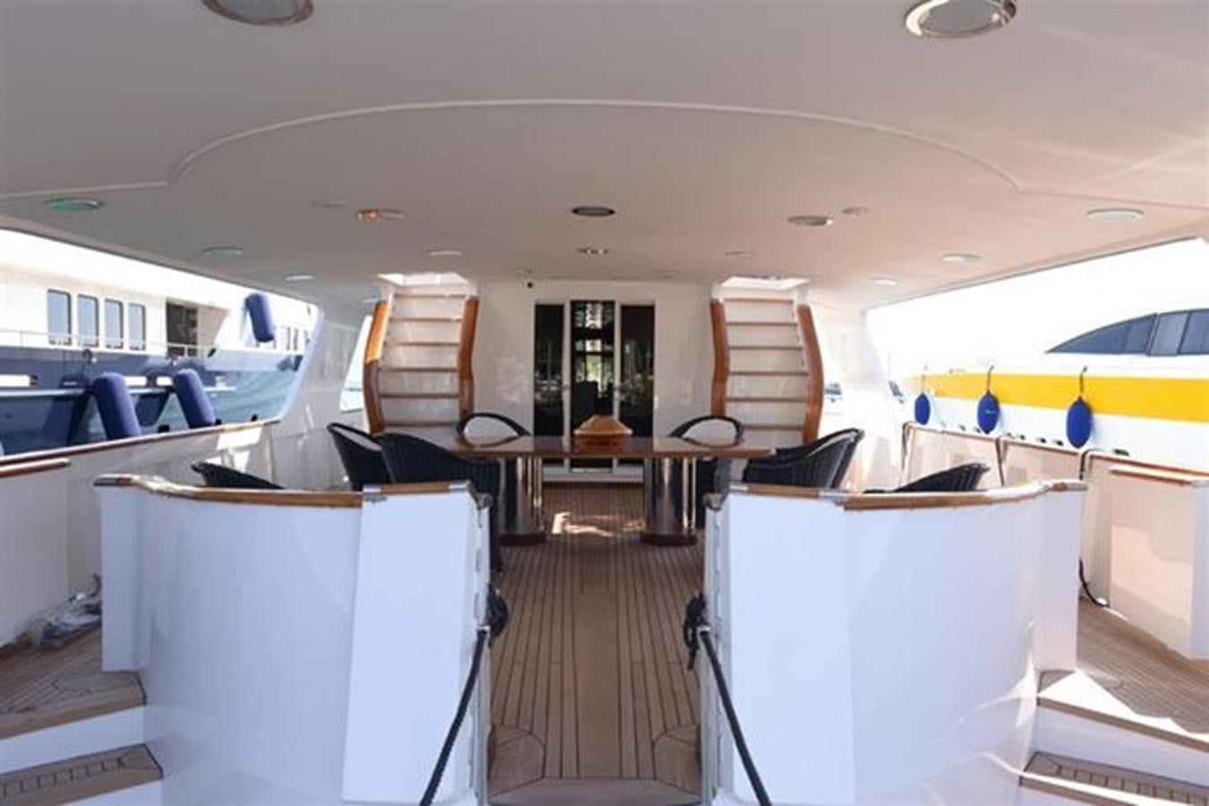 a boat with chairs and tables aboard MISTER P Yacht for Sale