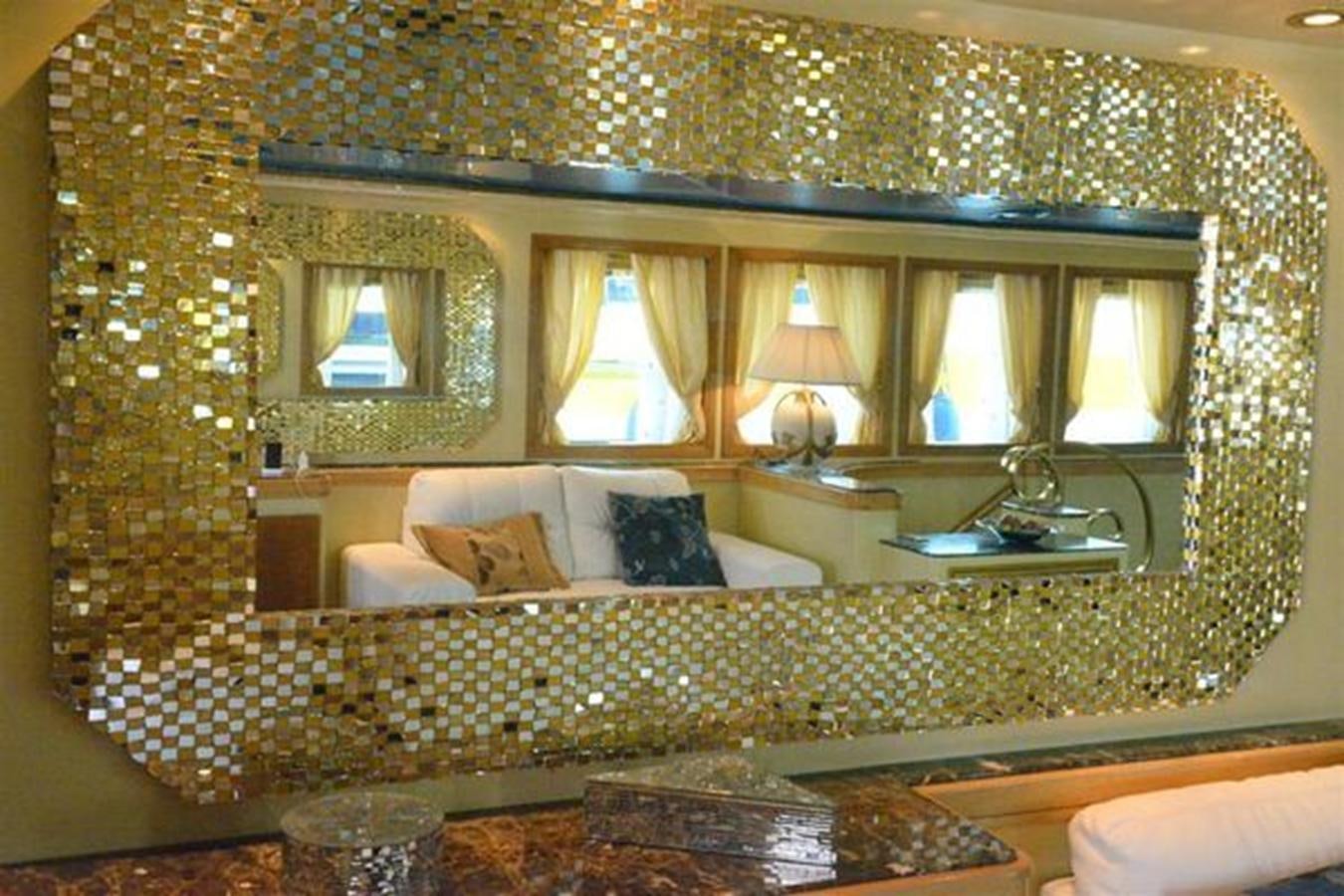 a large bed with a chandelier aboard MISTER P Yacht for Sale