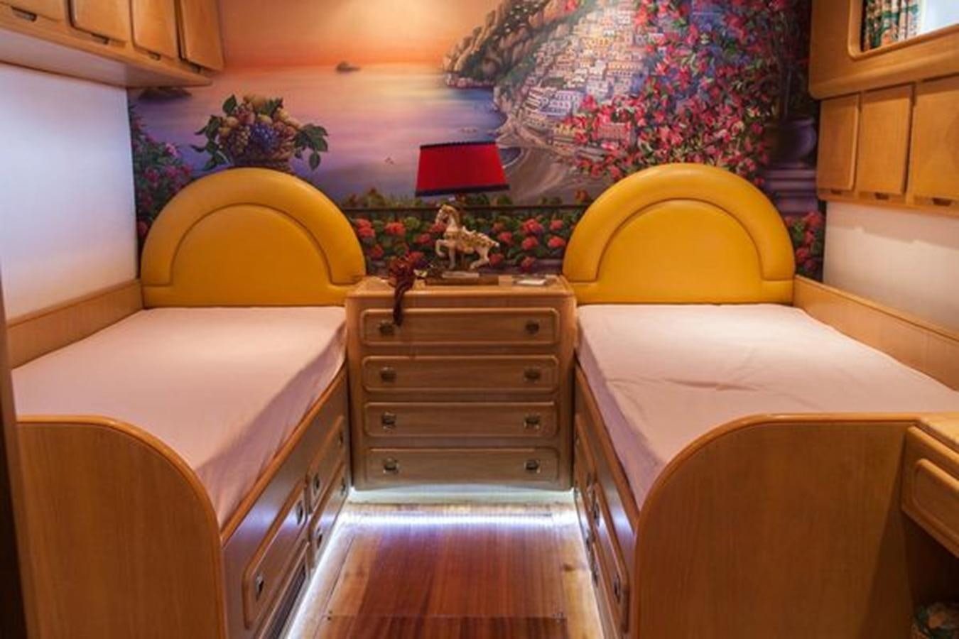 a room with a bed and a dresser aboard MISTER P Yacht for Sale