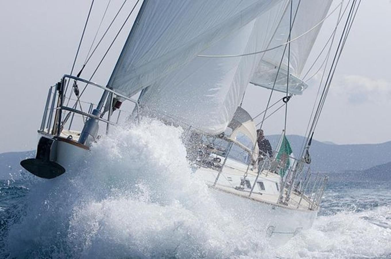 a man on a sailboat aboard WHITE DOLPHIN Yacht for Sale