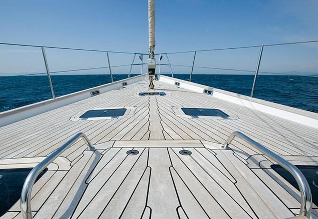 a wooden dock with a railing and water in the background aboard WHITE DOLPHIN Yacht for Sale