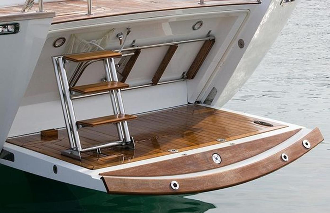a wooden boat on a deck aboard WHITE DOLPHIN Yacht for Sale