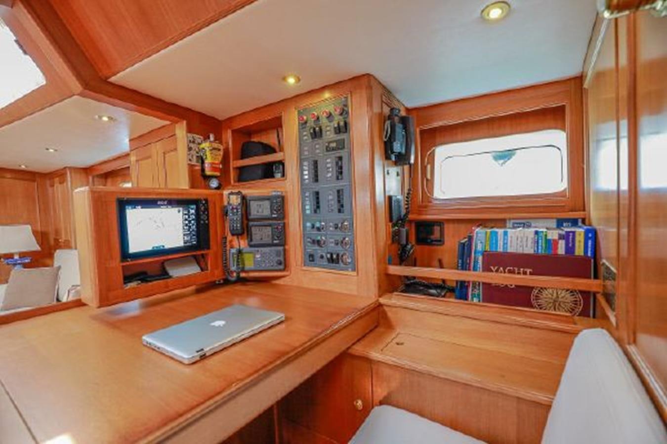 a laptop sits on a desk aboard WHITE DOLPHIN Yacht for Sale