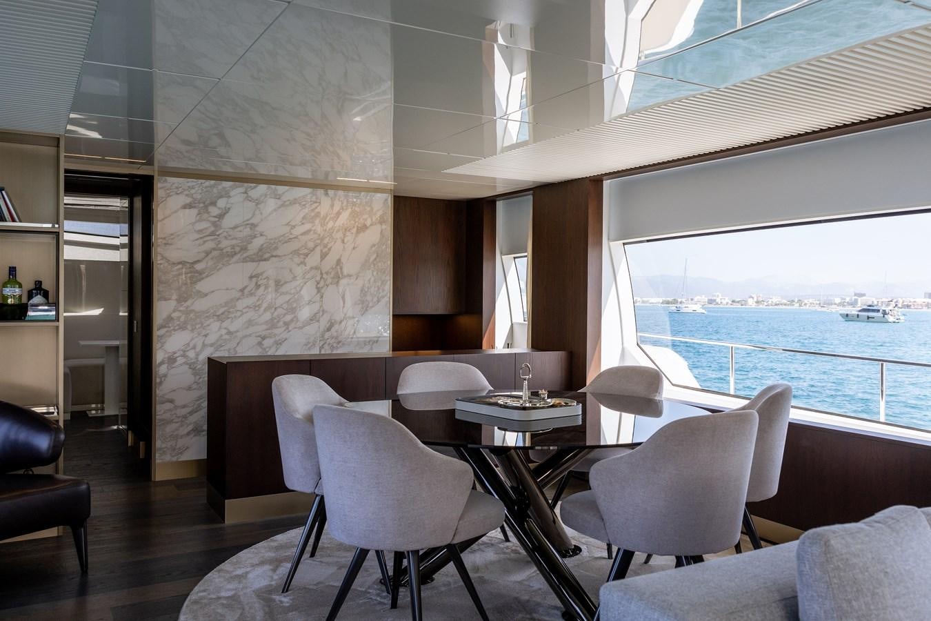 a room with tables and chairs aboard LEWENSLUST Yacht for Sale