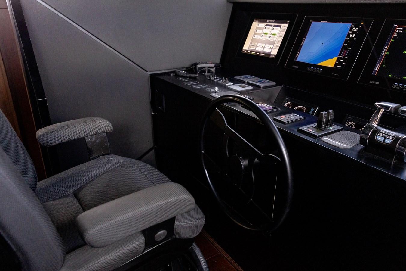 a black computer desk with a black chair and a black computer monitor aboard LEWENSLUST Yacht for Sale