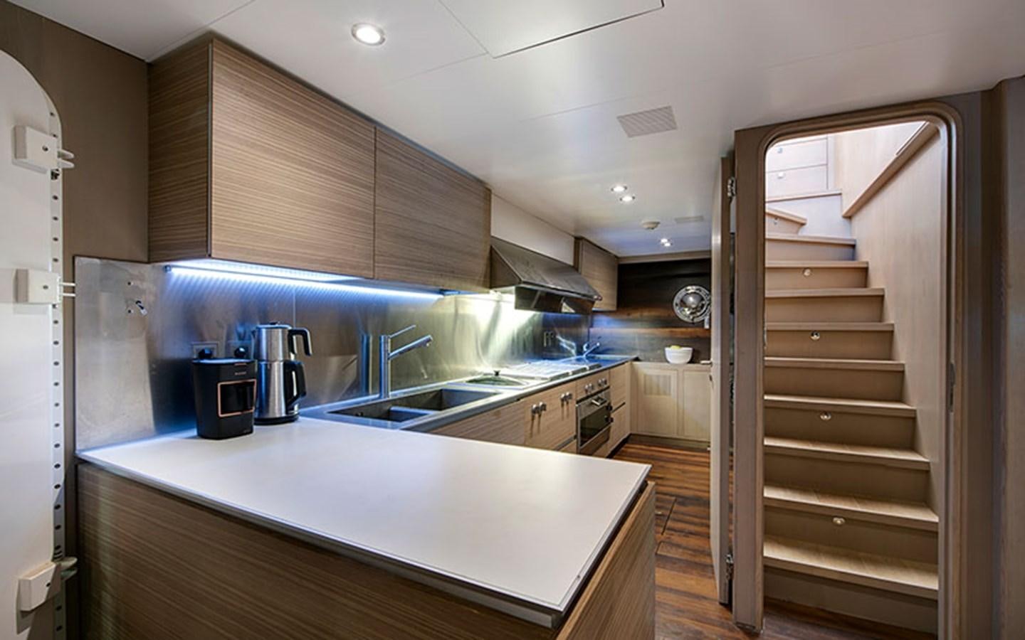 a kitchen with a large wooden shelving unit aboard ATLANTIKA Yacht for Sale