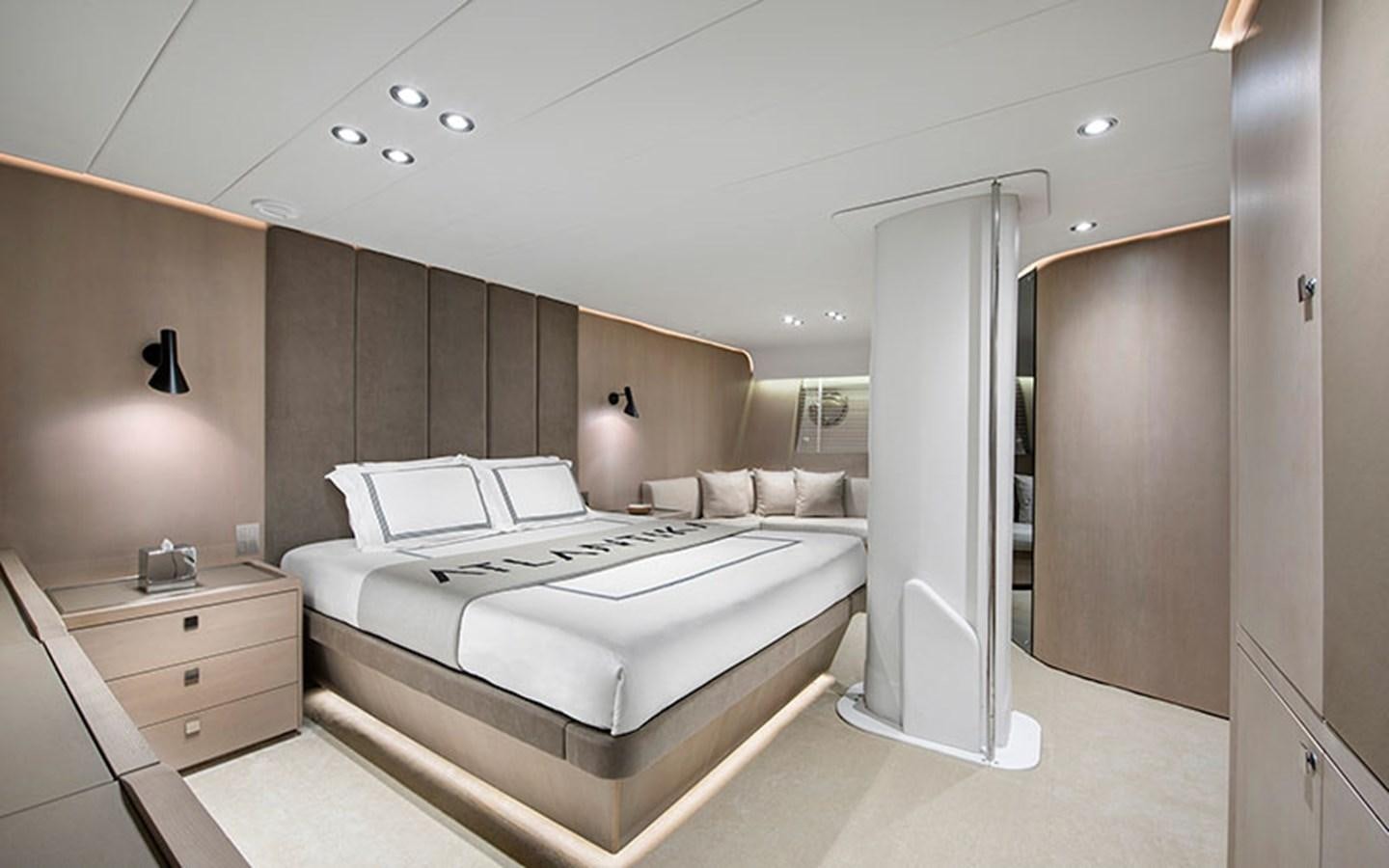 a room with a bed and a desk aboard ATLANTIKA Yacht for Sale