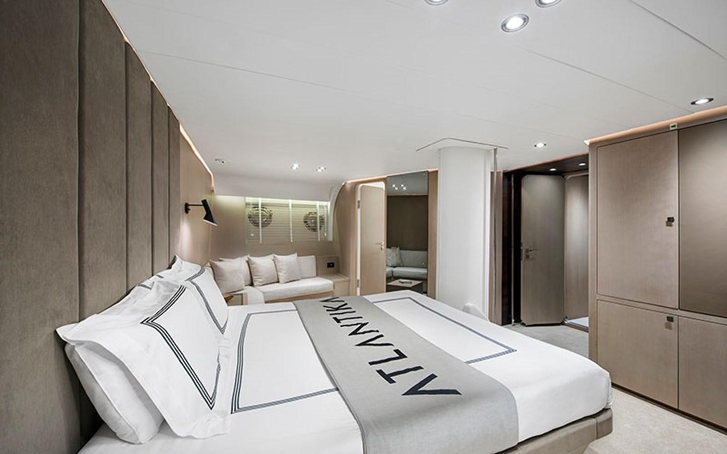 a room with a bed and a desk aboard ATLANTIKA Yacht for Sale