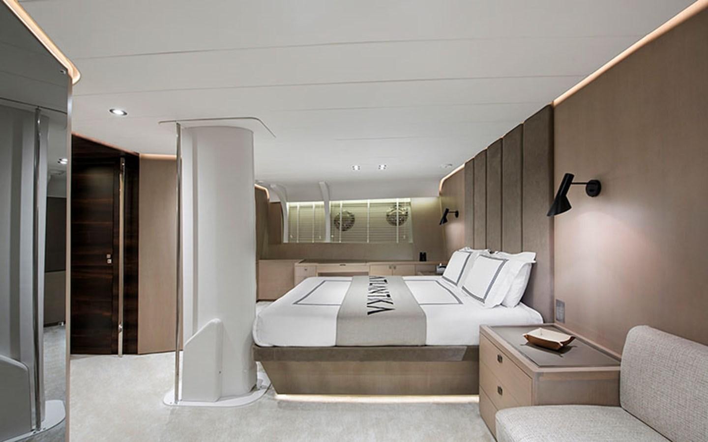 a room with a bed and a desk aboard ATLANTIKA Yacht for Sale