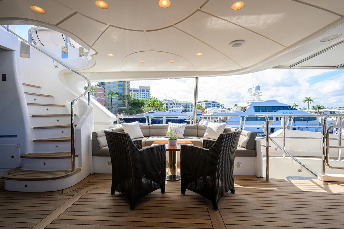 a room with a table chairs and a large window with a view of the city aboard ARTHUR’S WAY Yacht for Sale