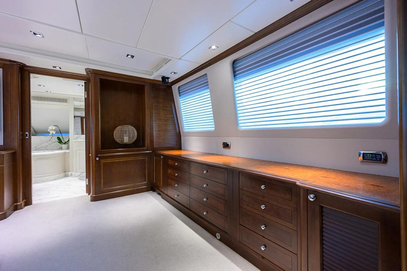 a room with a large window and a dresser with a mirror aboard ARTHUR’S WAY Yacht for Sale