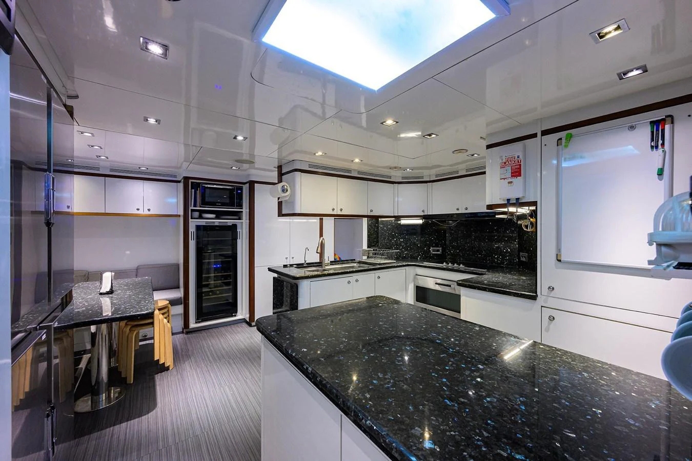 a kitchen with white cabinets aboard ARTHUR’S WAY Yacht for Sale