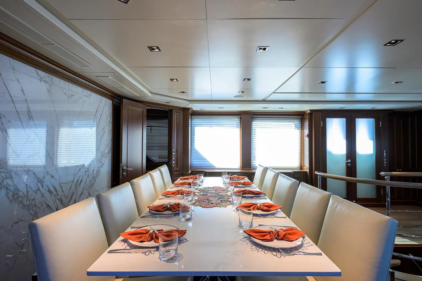 a table with plates and glasses on it aboard ARTHUR’S WAY Yacht for Sale