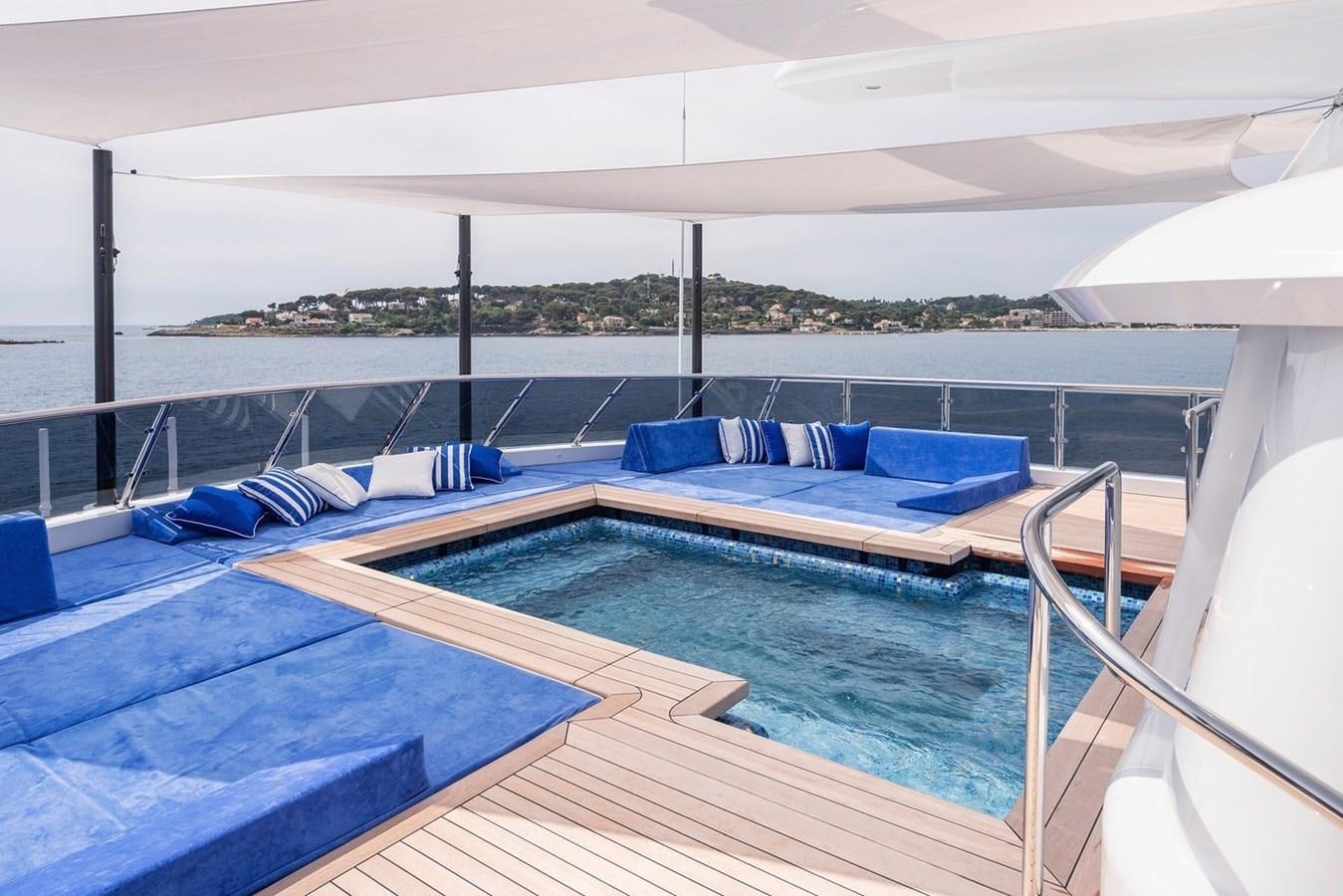 a pool with a deck and a view of the water aboard MY LEGACY Yacht for Sale