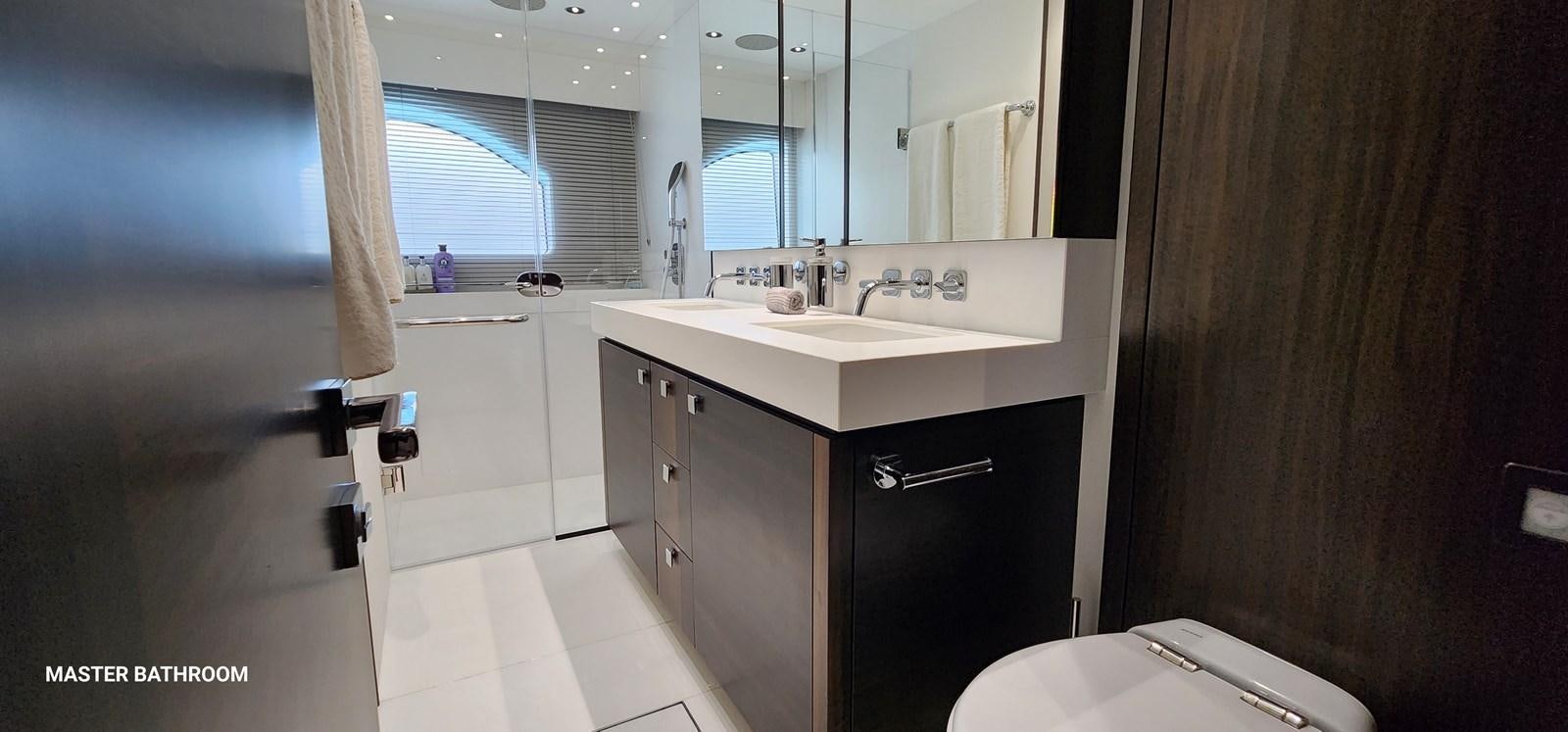 a bathroom with a sink and a mirror aboard EL 5 MARES Yacht for Sale