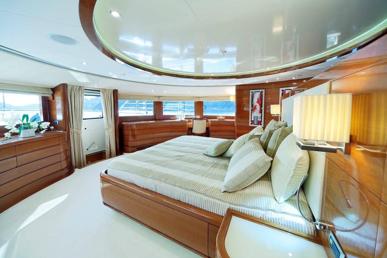 a room with a bed and a window aboard HARMONY III Yacht for Sale