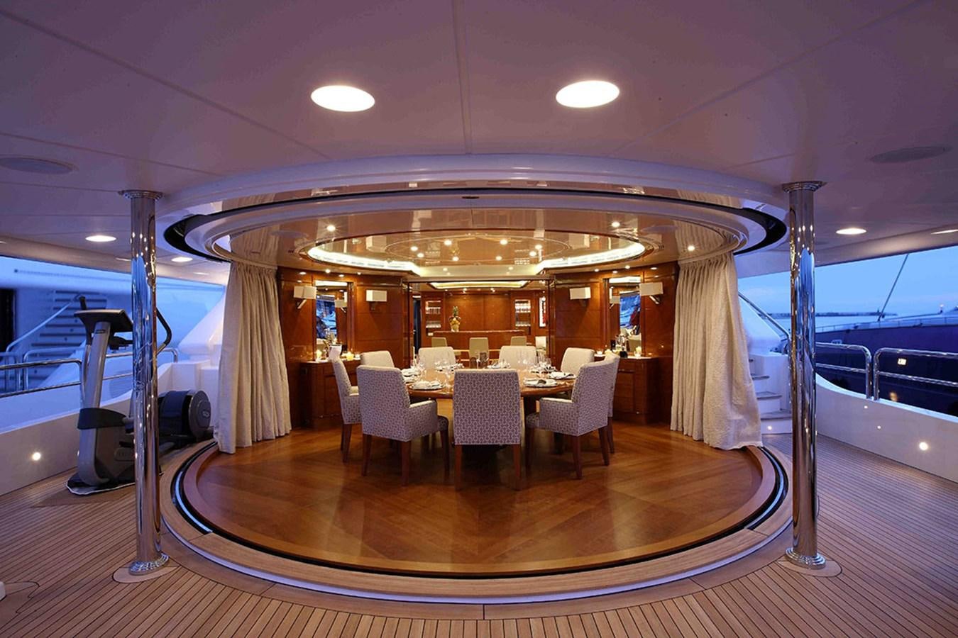 a large room with a table and chairs aboard HARMONY III Yacht for Sale