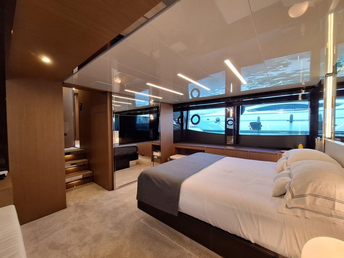 a bedroom with a large window aboard CHILUCE Yacht for Sale