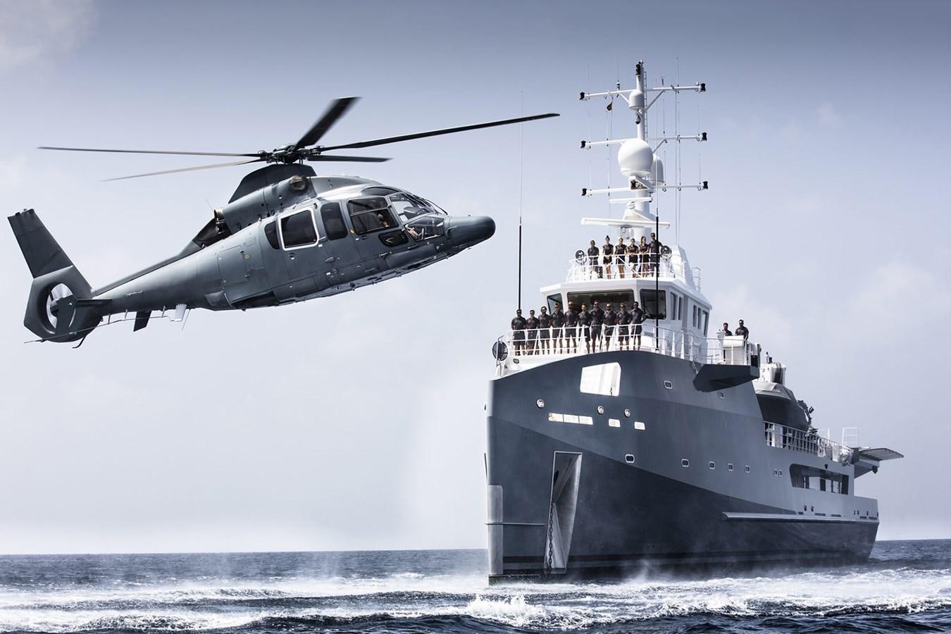 a helicopter flying over a ship aboard WINGMAN Yacht for Sale
