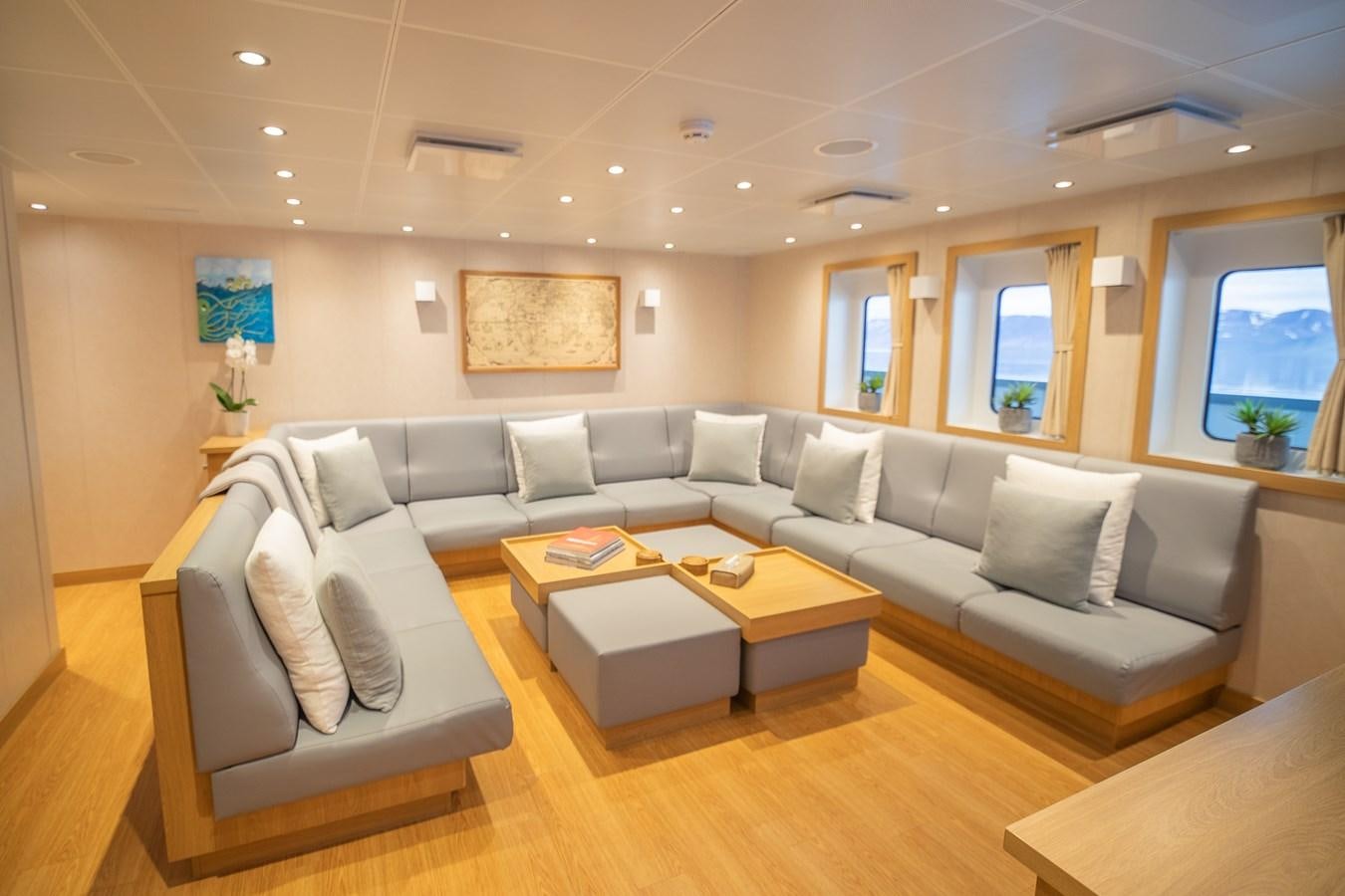 a living room with a couch and a coffee table aboard WINGMAN Yacht for Sale