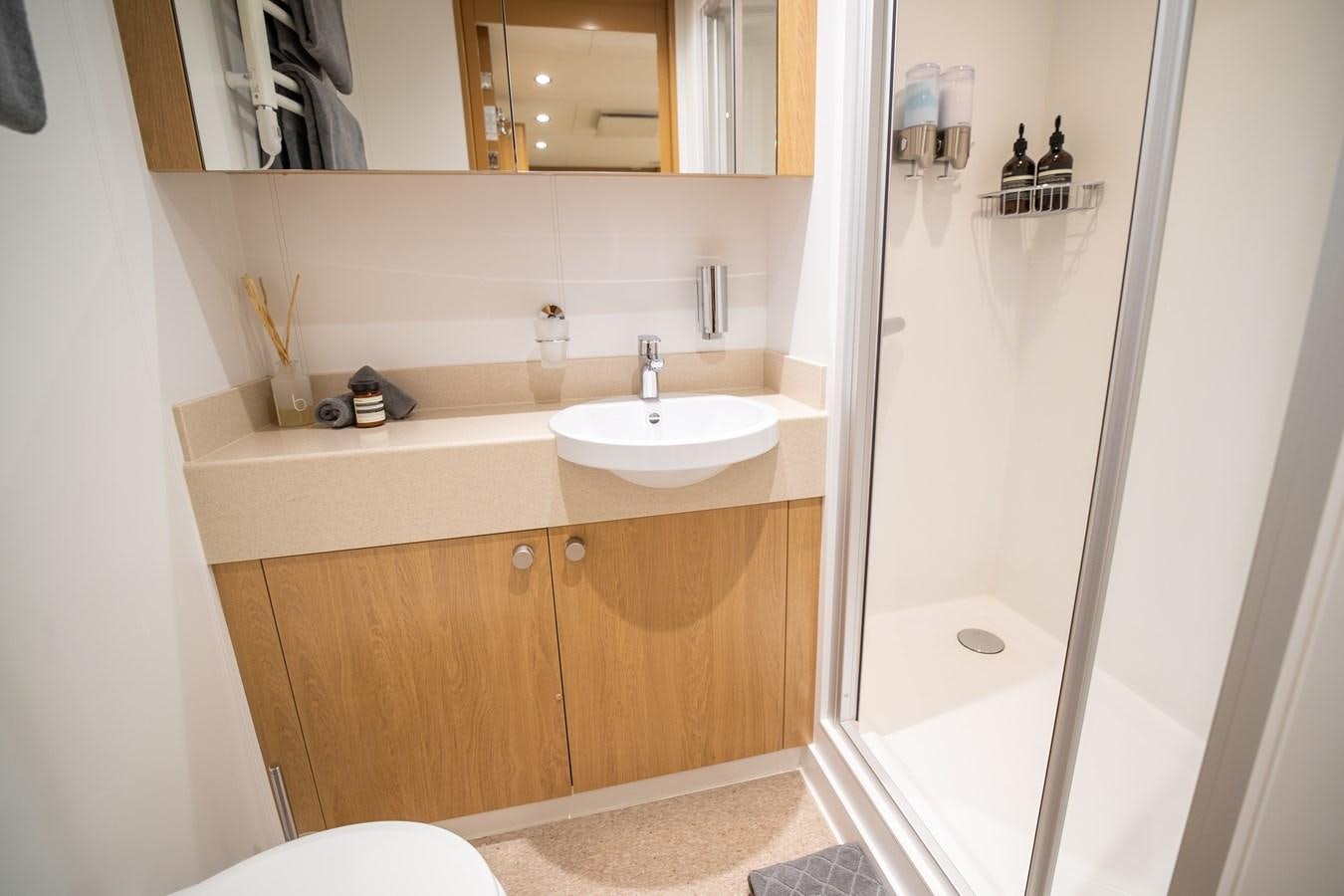 a bathroom with a sink and a shower aboard WINGMAN Yacht for Sale
