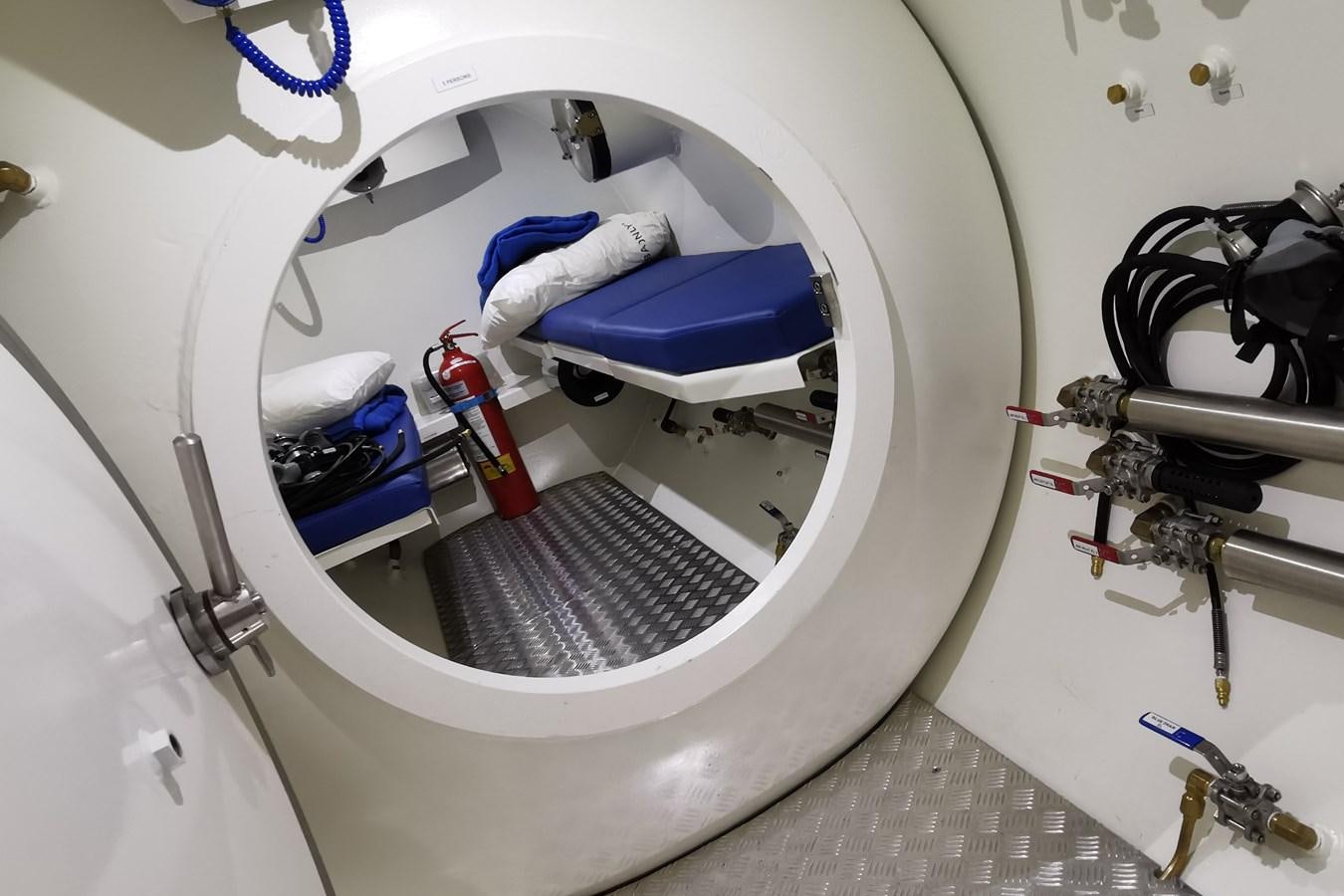 a white car with a blue hood aboard WINGMAN Yacht for Sale