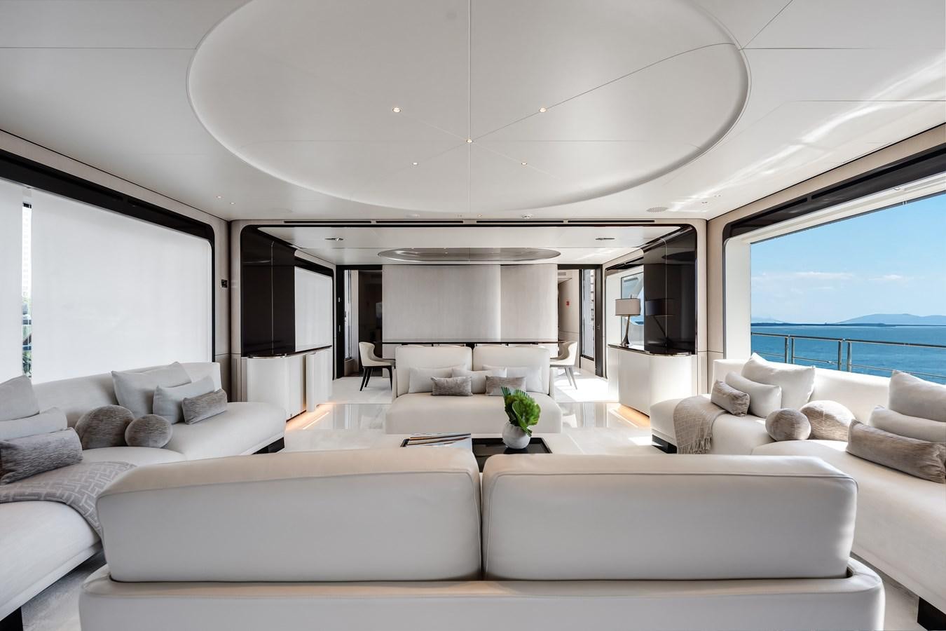 a living room with white furniture aboard AMICO Yacht for Sale