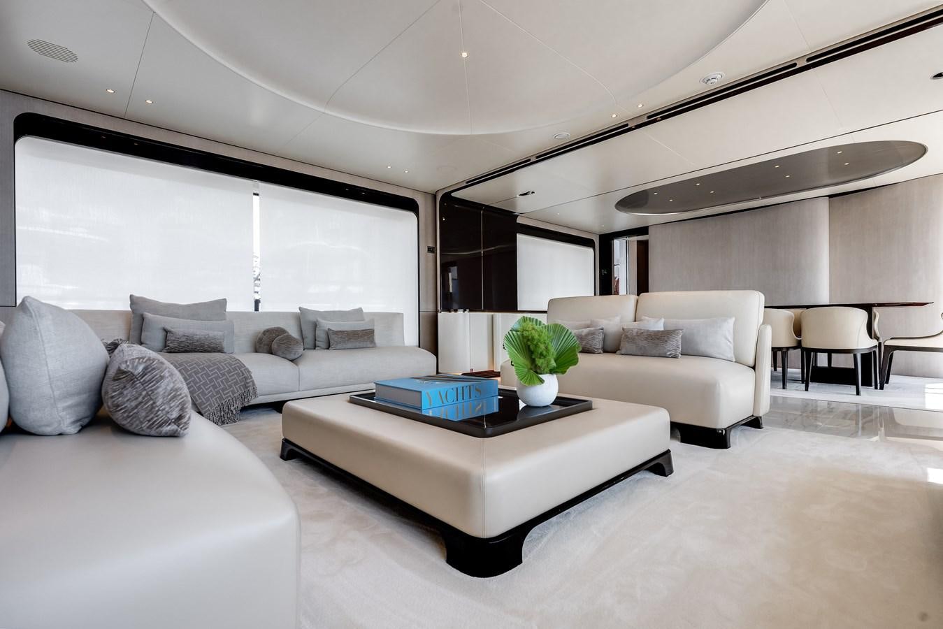 a living room with a couch and a table aboard AMICO Yacht for Sale