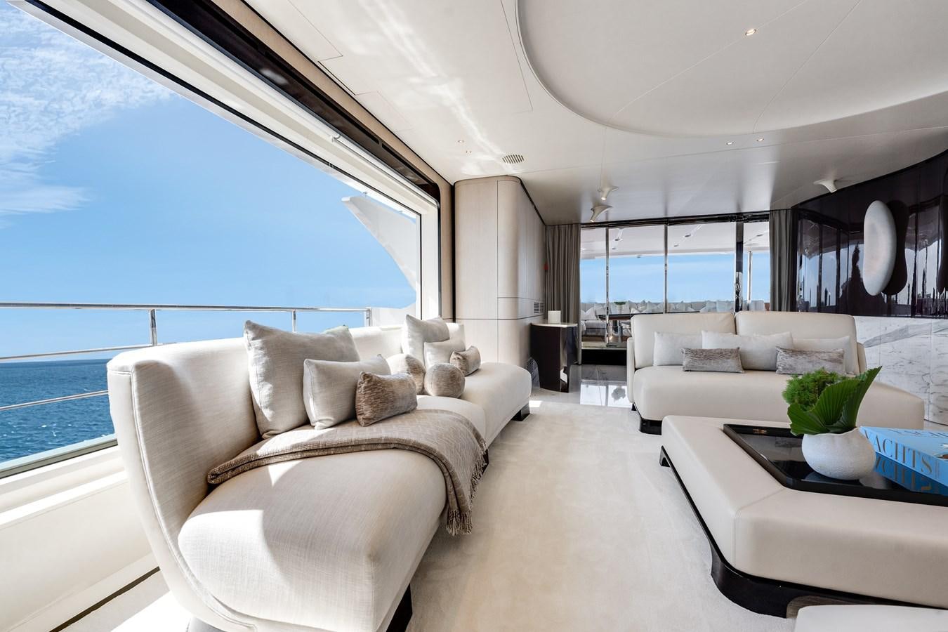 a living room with a large window aboard AMICO Yacht for Sale