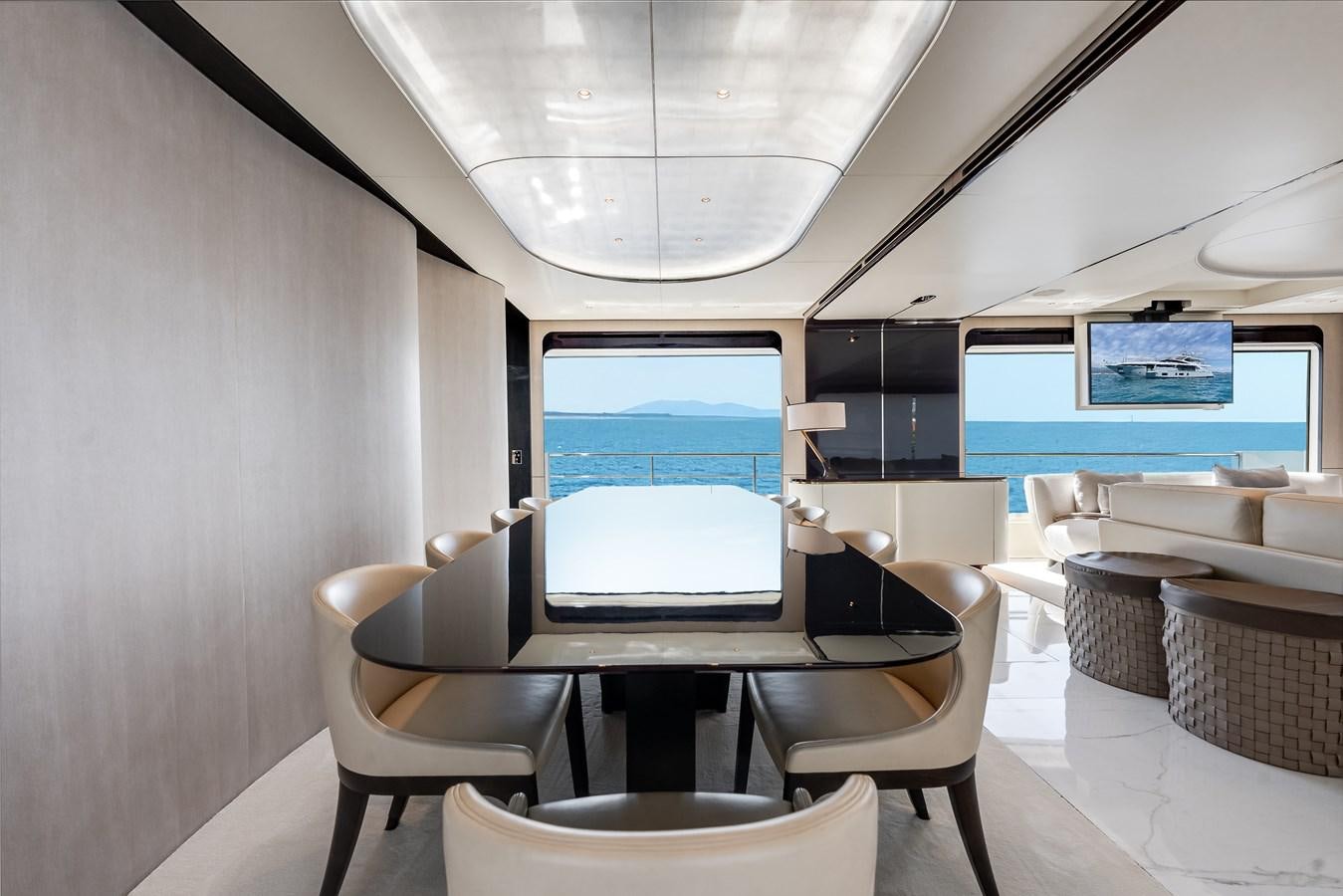 a room with a table and chairs aboard AMICO Yacht for Sale