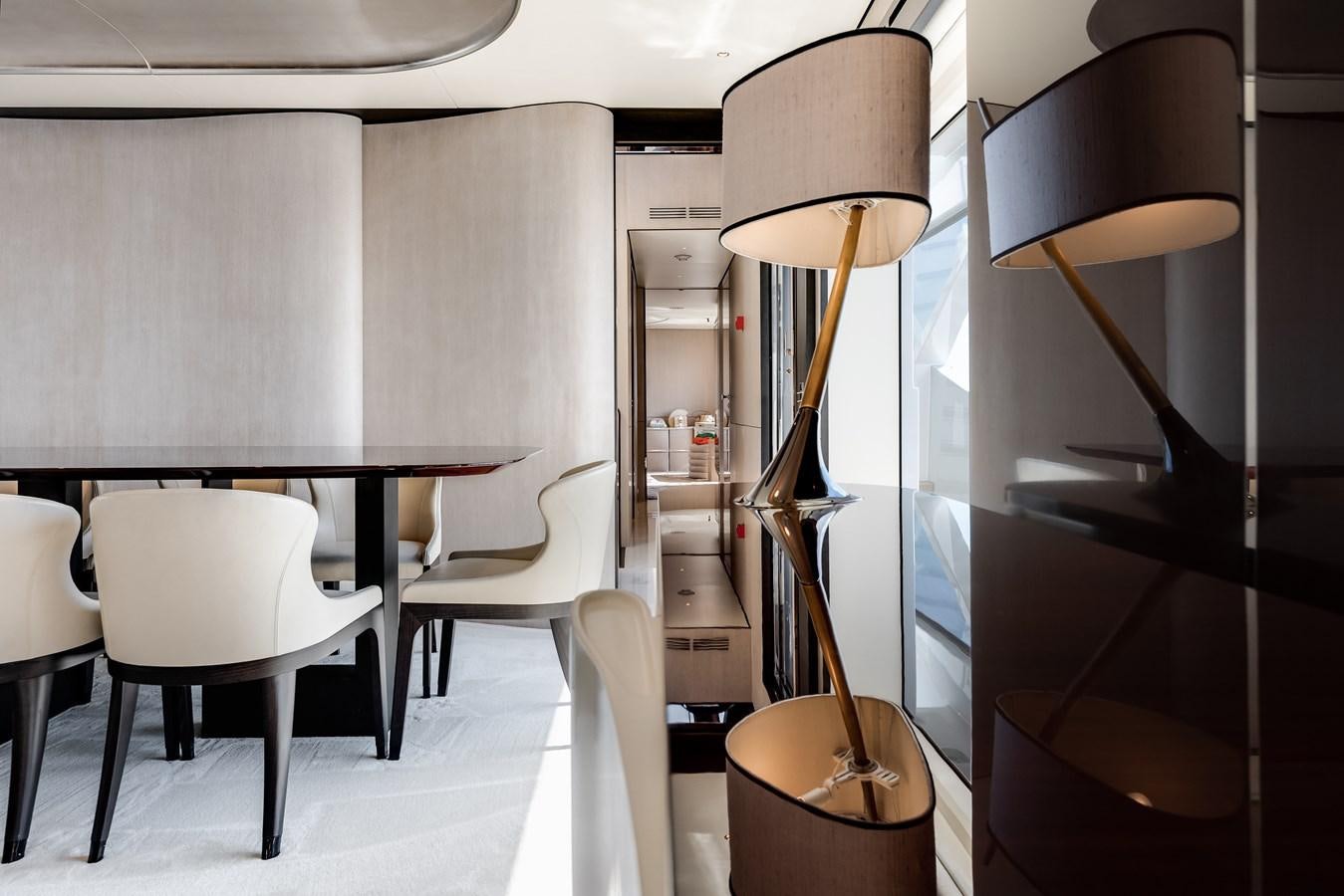 a room with a table and chairs aboard AMICO Yacht for Sale