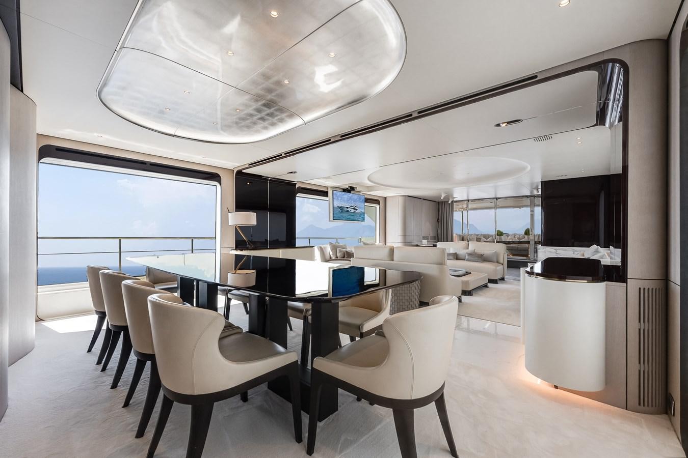 a room with a table and chairs aboard AMICO Yacht for Sale