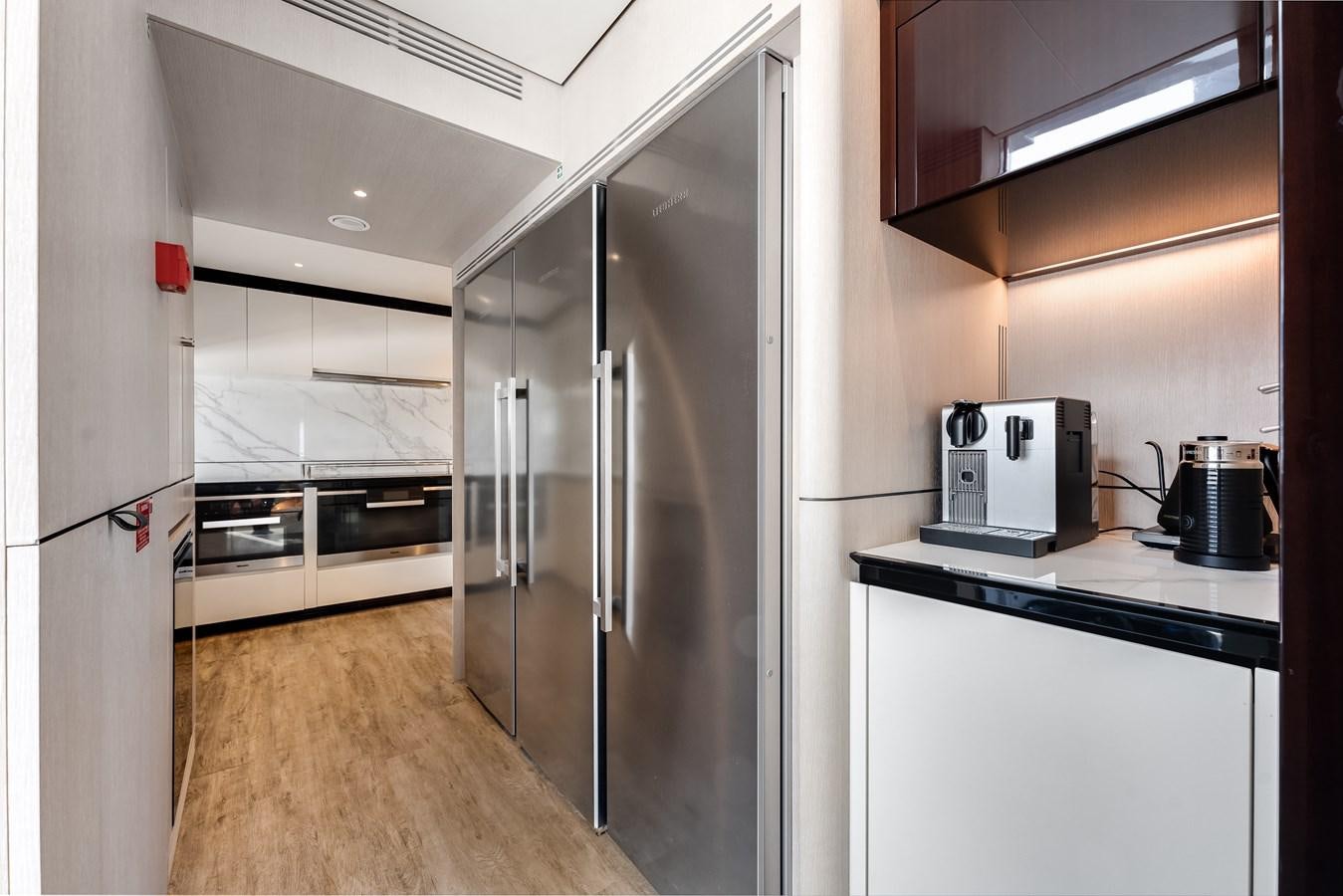a kitchen with stainless steel appliances aboard AMICO Yacht for Sale