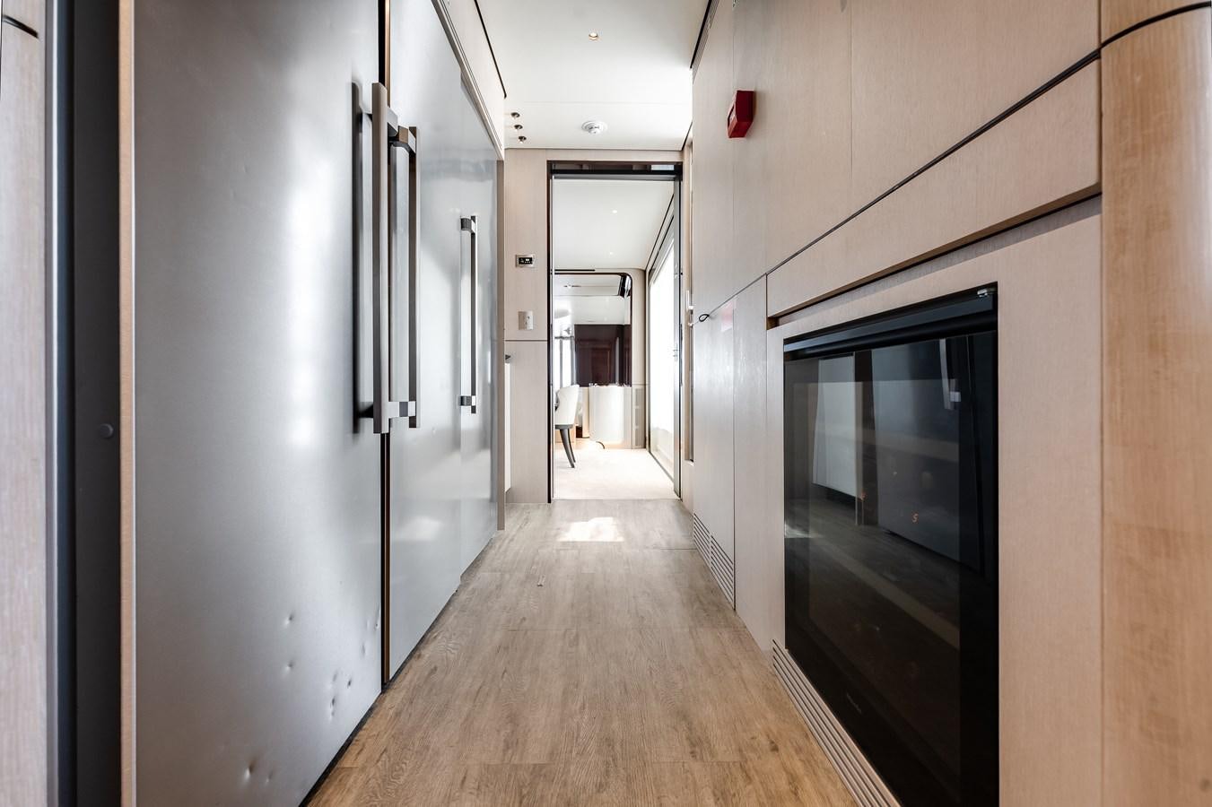a hallway with a wood floor and a large mirror aboard AMICO Yacht for Sale