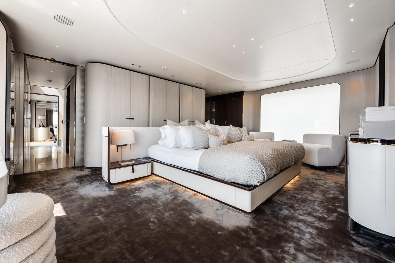 a large bedroom with a bed aboard AMICO Yacht for Sale