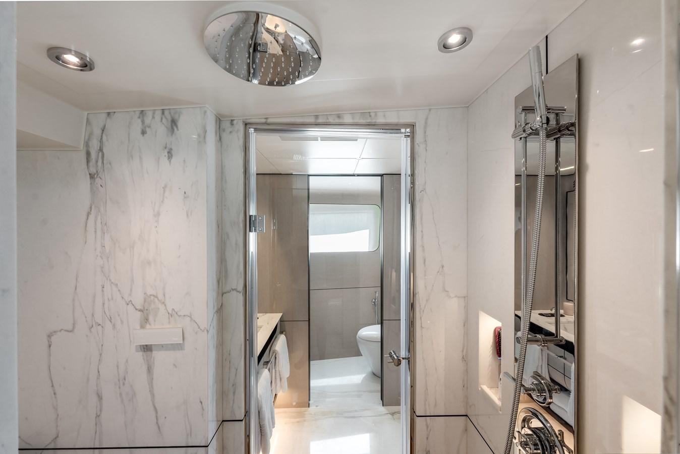 a bathroom with a shower and toilet aboard AMICO Yacht for Sale