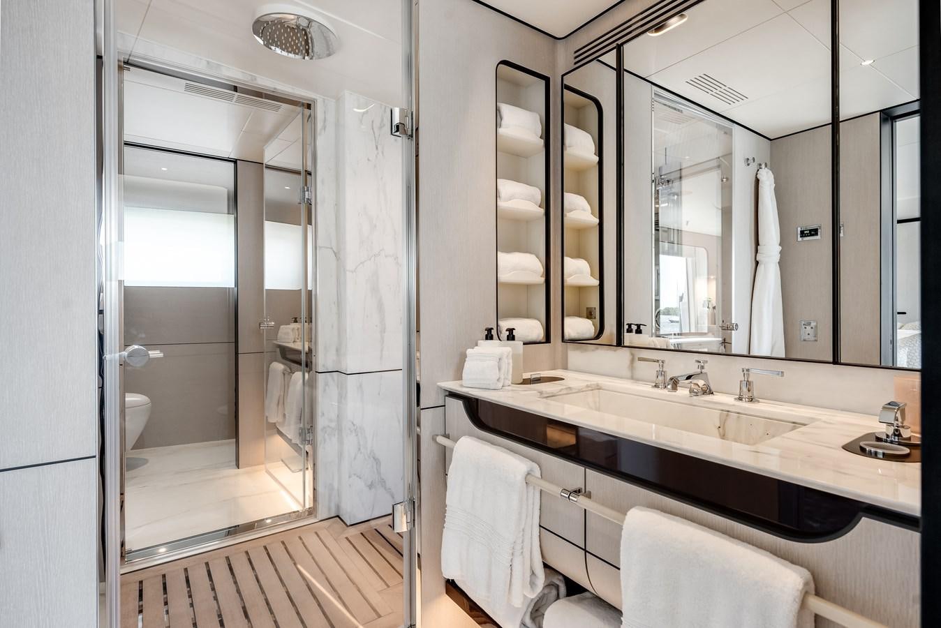 a bathroom with a large mirror aboard AMICO Yacht for Sale