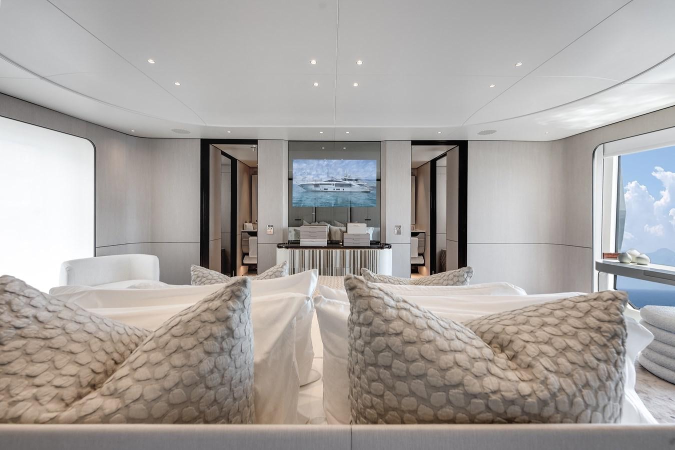 a large living room with a large window aboard AMICO Yacht for Sale