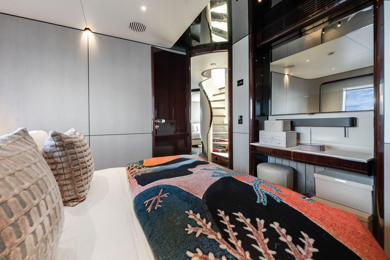 a bed with a blue blanket aboard AMICO Yacht for Sale