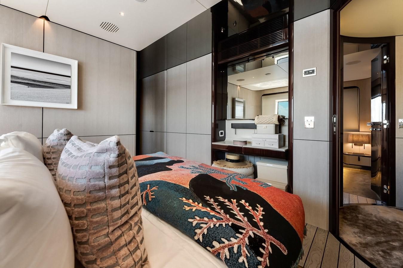 a bedroom with a bed and a mirror aboard AMICO Yacht for Sale