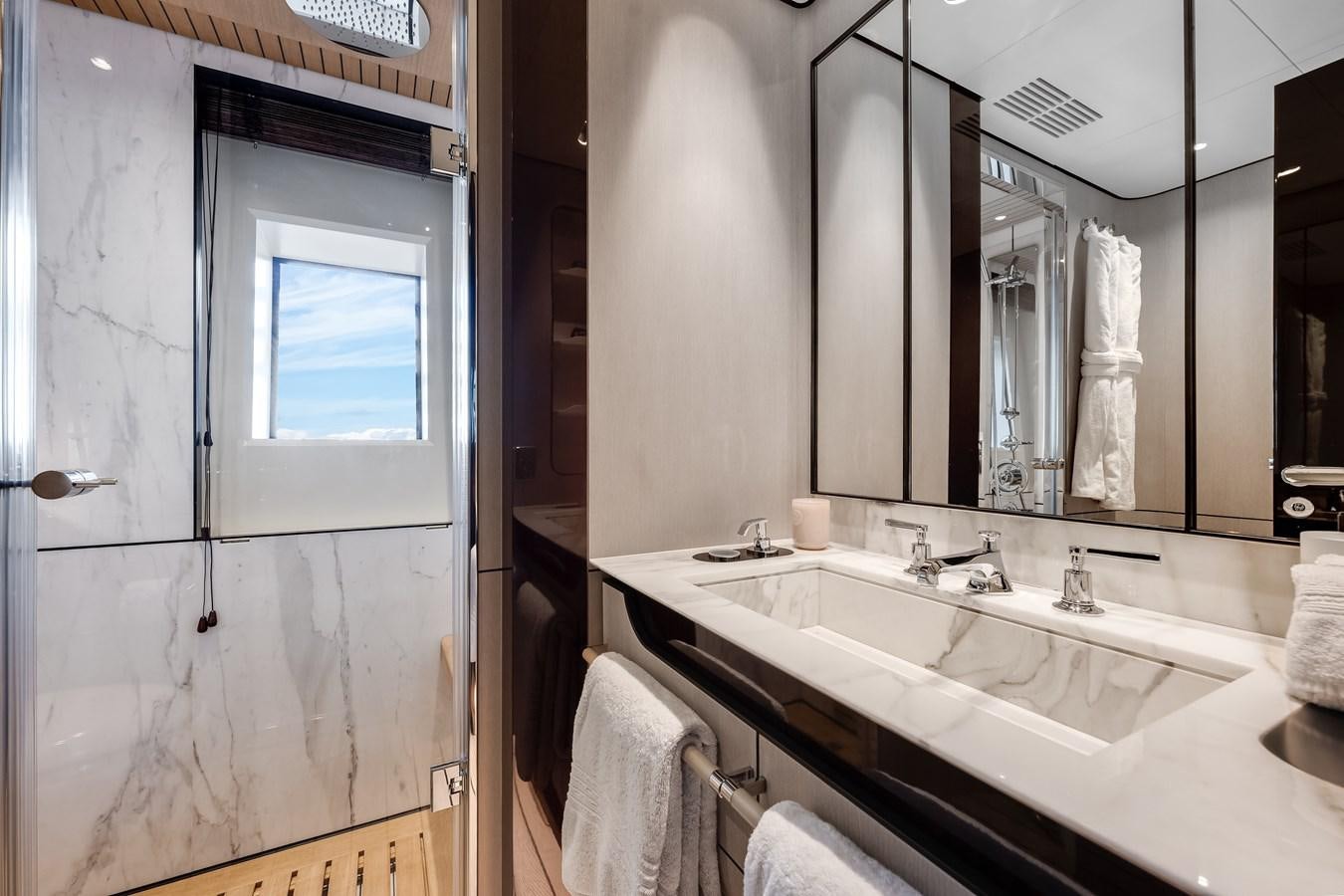 a bathroom with a large mirror aboard AMICO Yacht for Sale