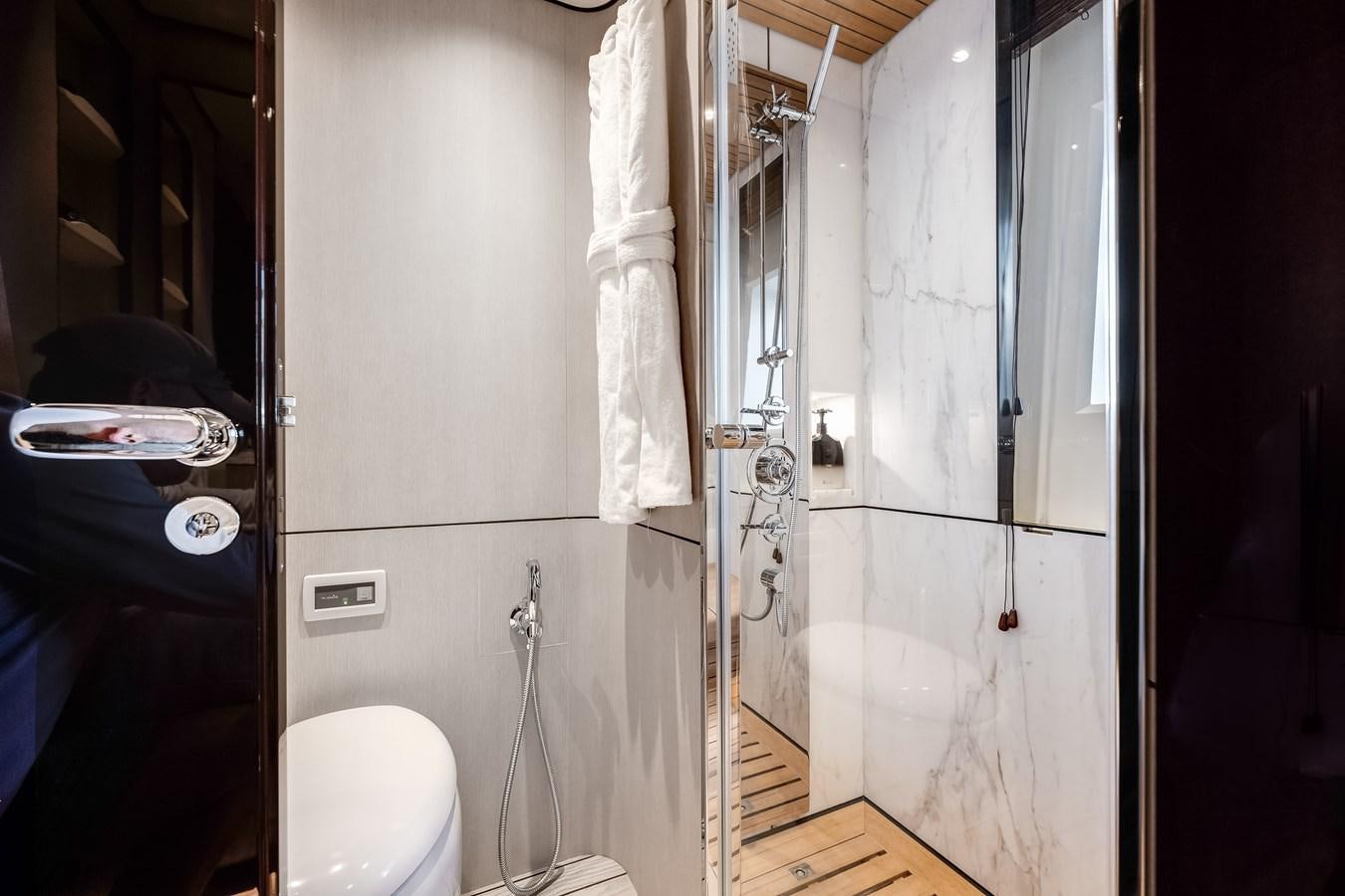 a bathroom with a shower and toilet aboard AMICO Yacht for Sale
