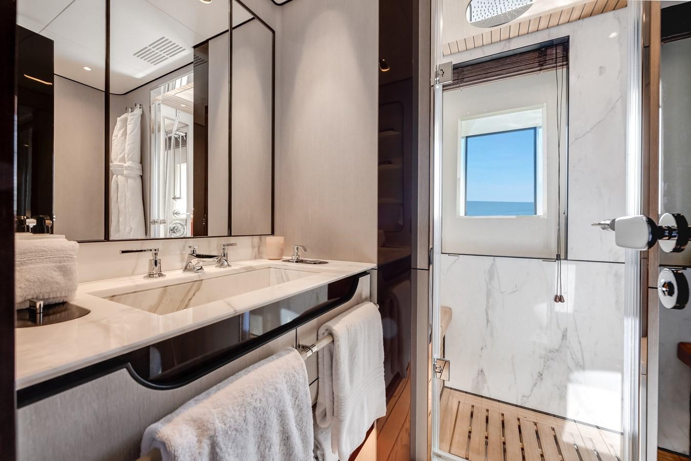 a bathroom with a sink and a mirror aboard AMICO Yacht for Sale
